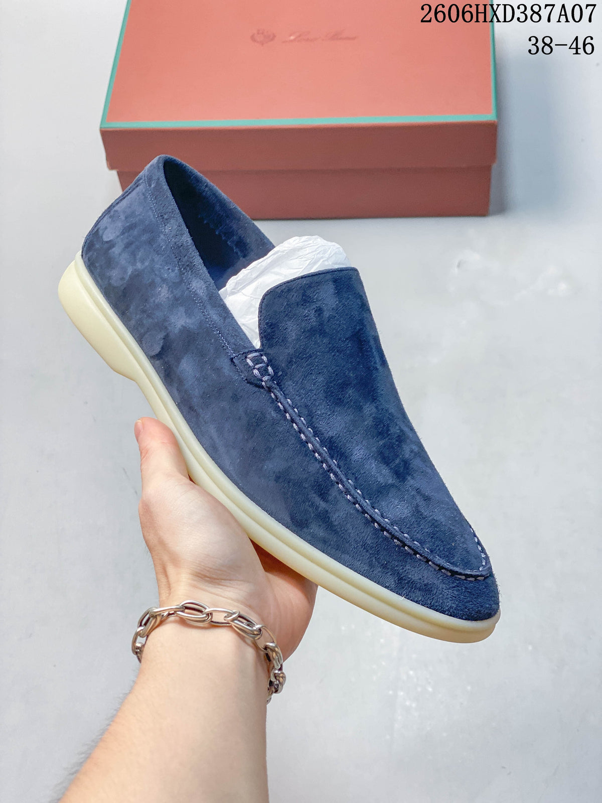Angled view of a blue slip-on loafer with stitched apron toe and light-colored sole.