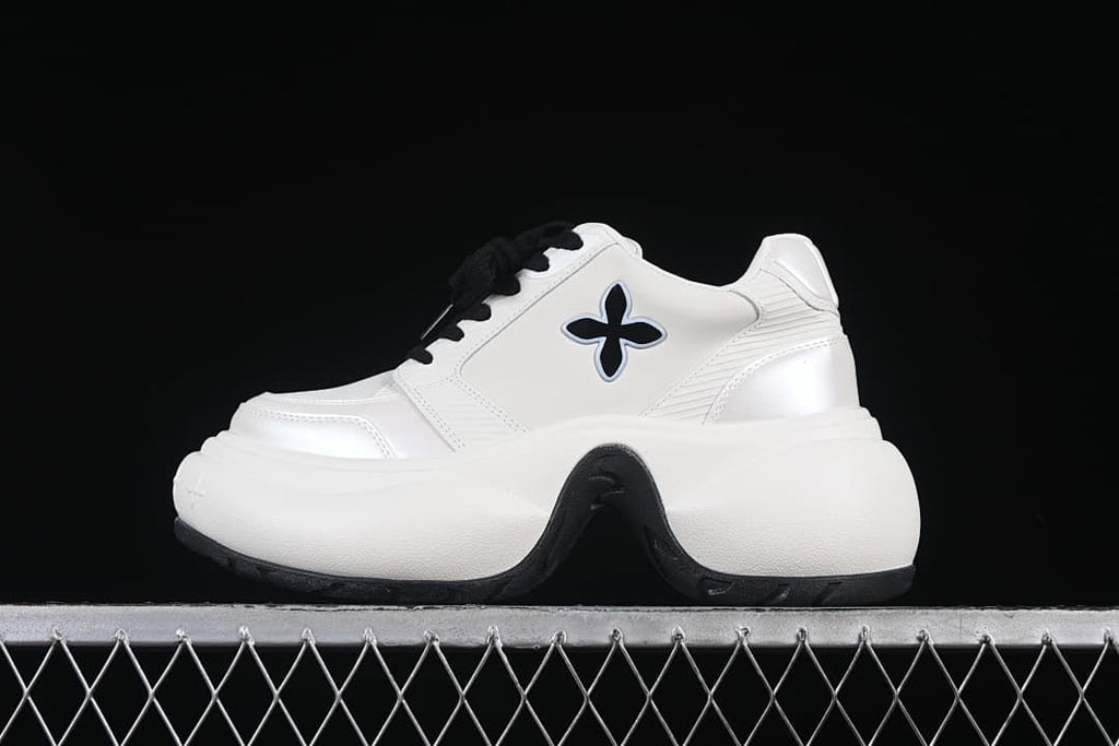 Side view of a white SMFK Future Ripple low-top sneaker with black laces and a thick sculpted sole