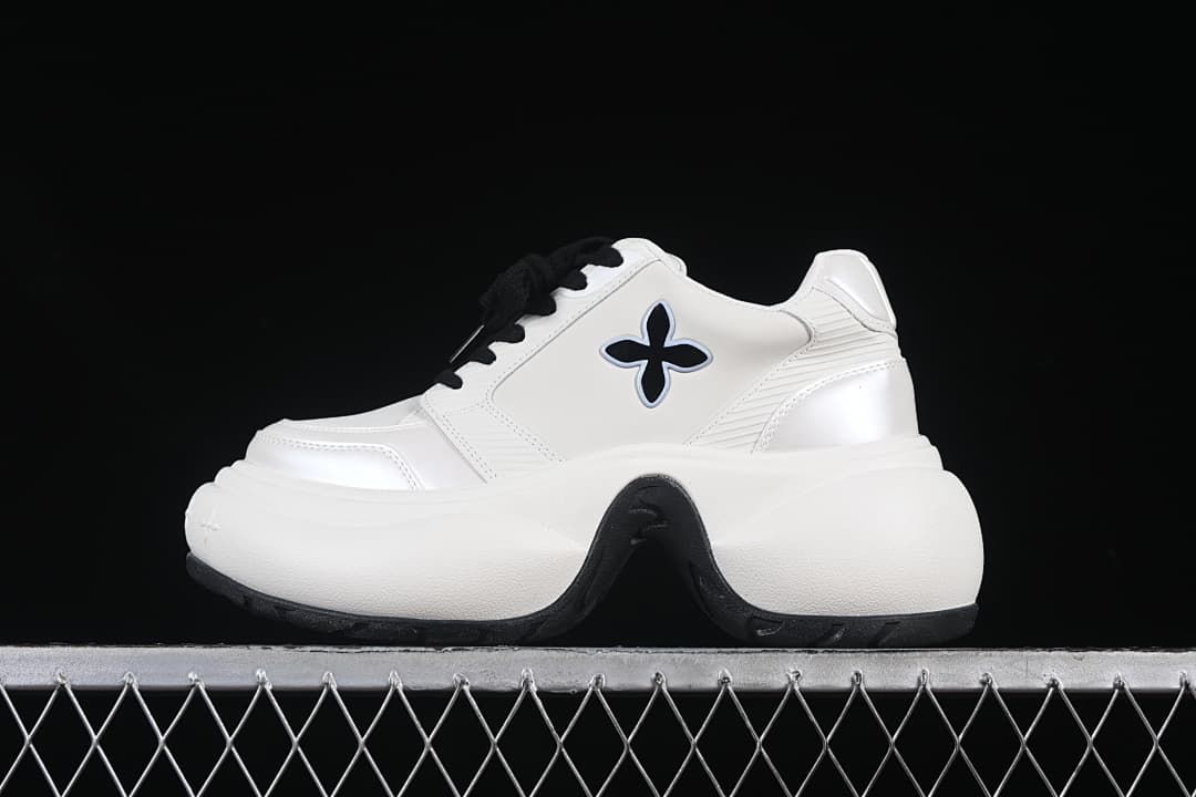 Side view of a white SMFK Future Ripple low-top sneaker with black laces and a thick sculpted sole