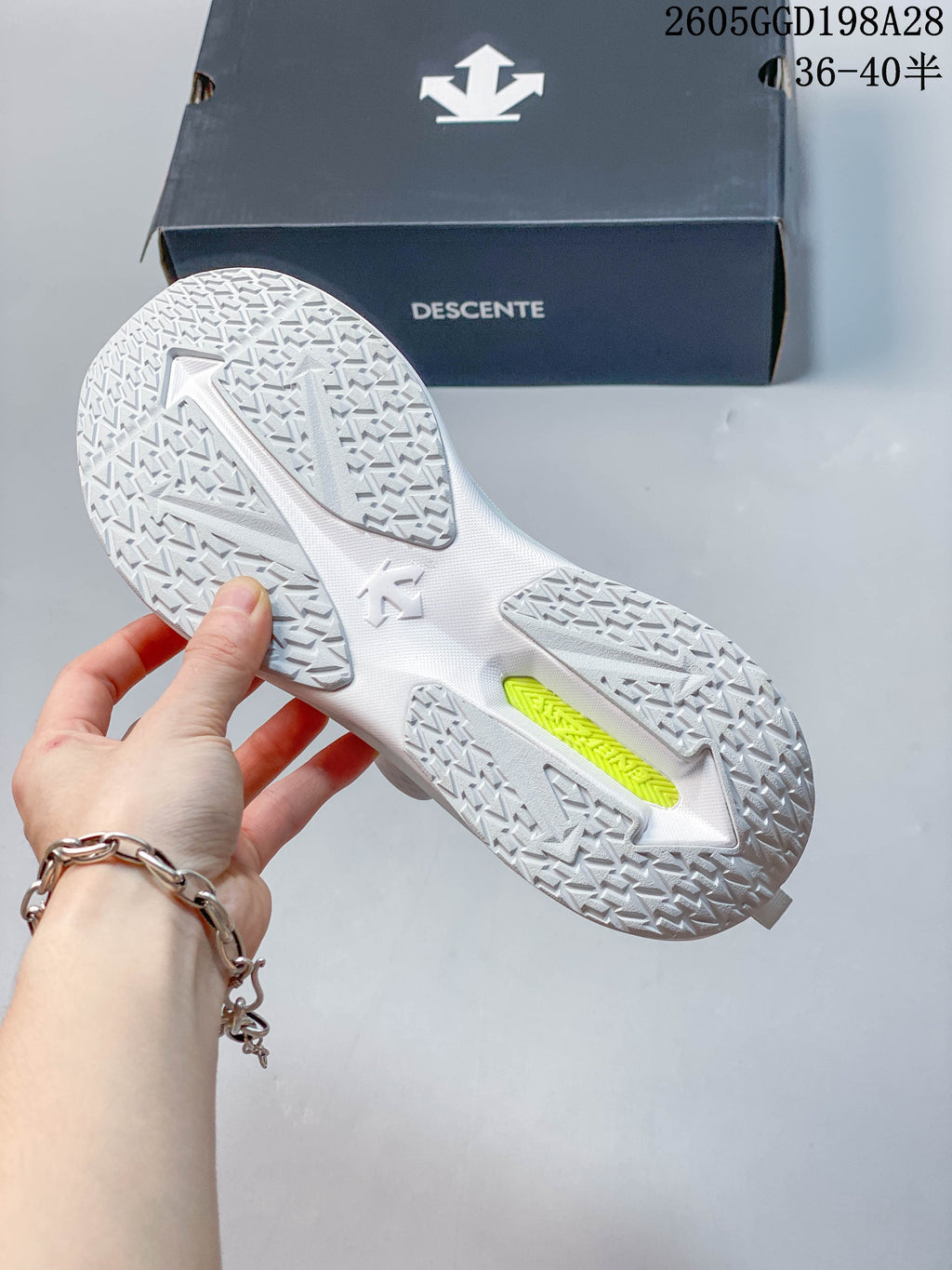 Patterned outsole of a white DESCENTE sneaker