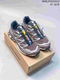 Pair of brown and gray Salomon XT-6 shoes on a box, viewed from above at an angle.