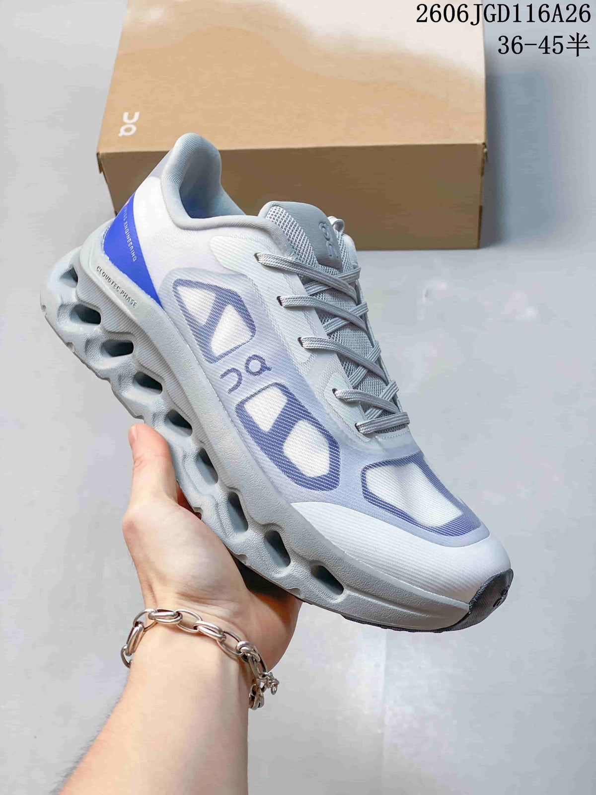 Close-up side view of a white On Cloudtilt Remix sneaker with lavender accents and a sculpted sole.