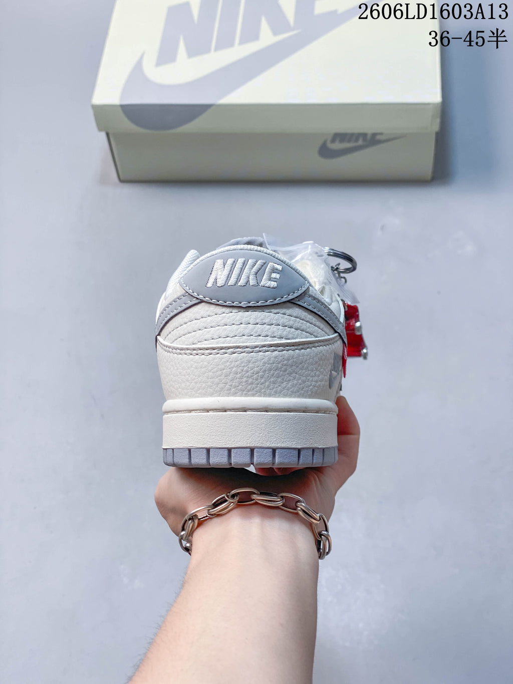 Rear view showing the grey heel tab and cream upper