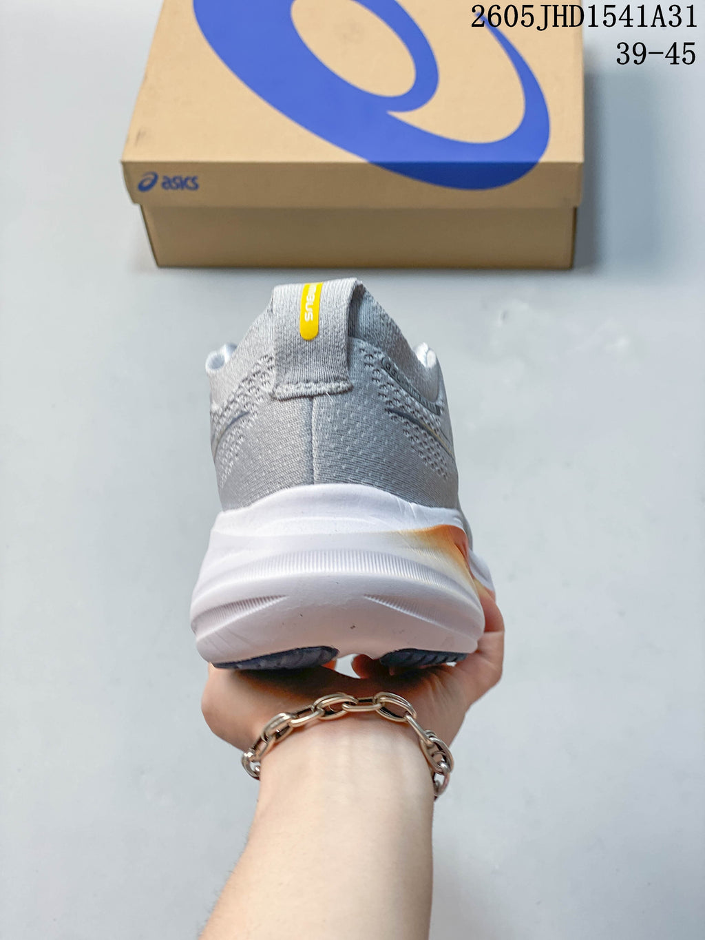 Rear view of the gray running shoe showing its padded heel and thick white midsole