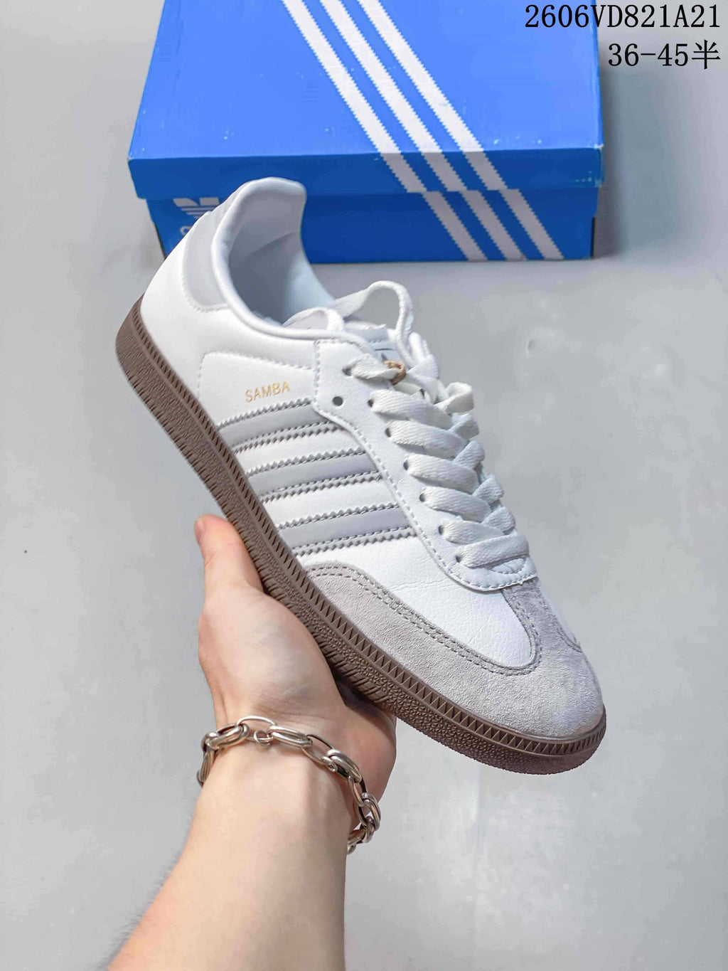 Side view of a white adidas Samba sneaker with grey stripes and gum-colored outsole