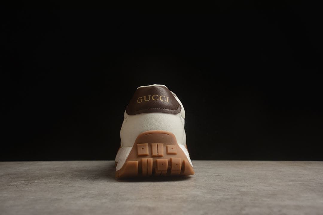 Rear view showing brown heel panel and gum-colored tread