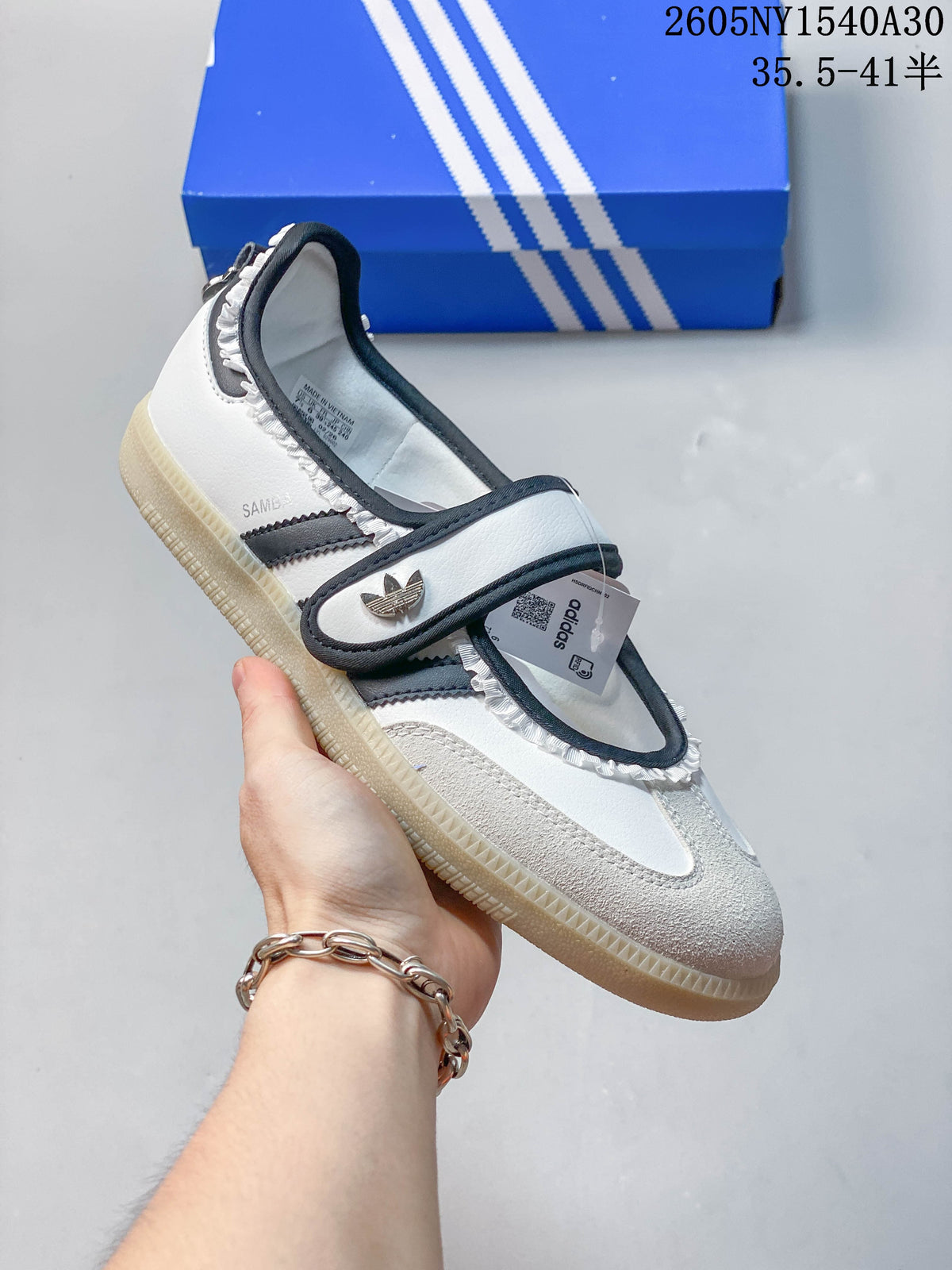 Angled view of the white and black Samba Jane sneaker with Mary Jane strap