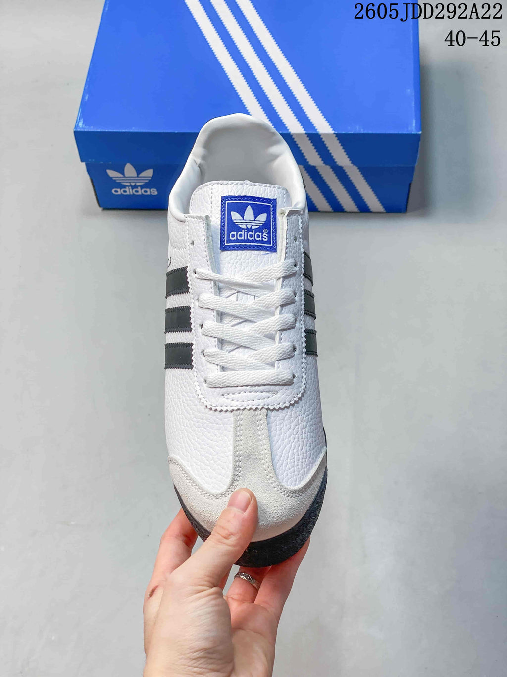 Top view of a white Adidas Samoa sneaker showing its laces and contrasting toe detail