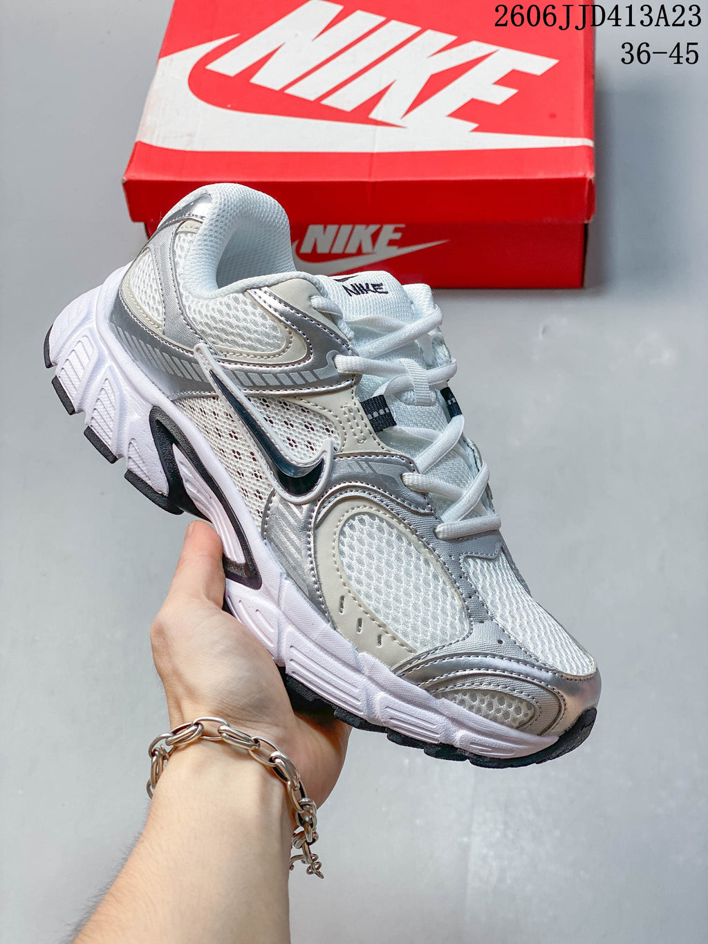 White and silver Nike Air Zoom Winflo 12 sneaker shown from the side.