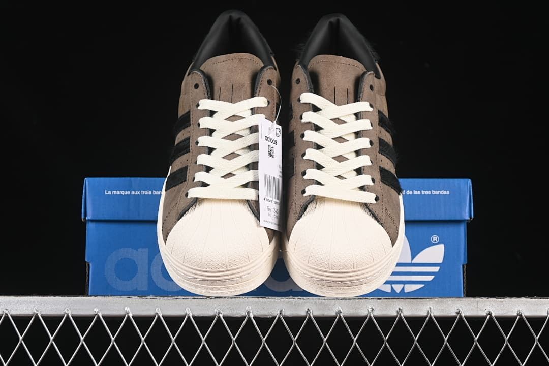 Front view of the pair showing shell toes and off-white laces