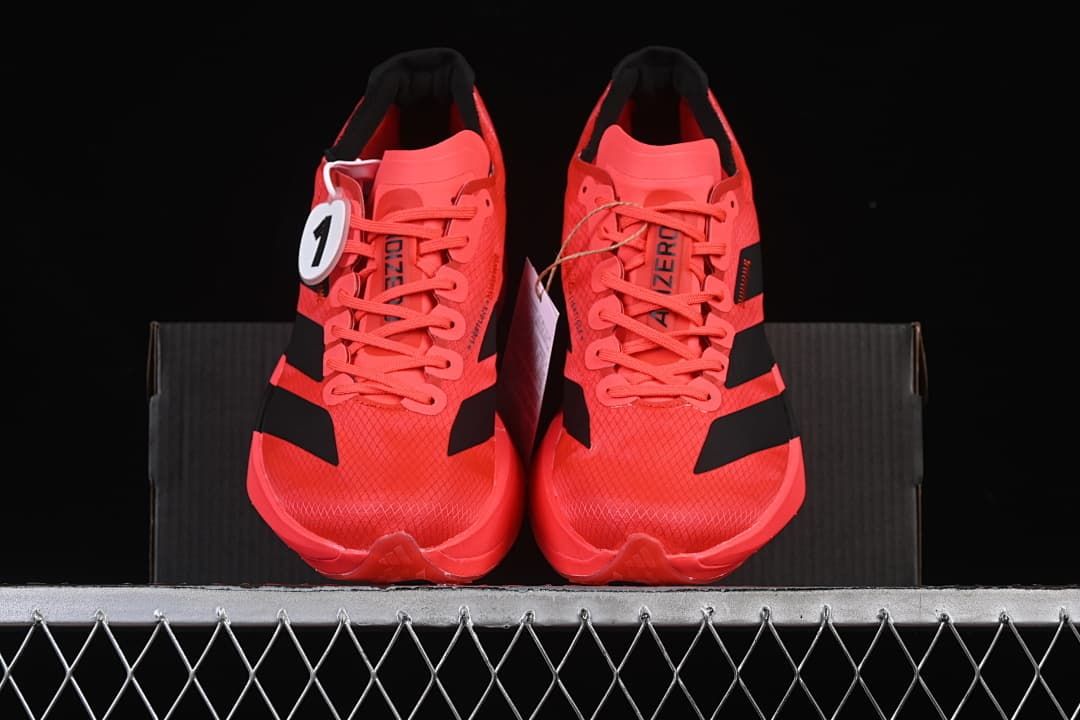 Front view of the pair of coral lace-up running shoes