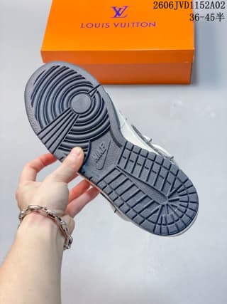 Underside view of the sneaker showing the gray rubber outsole with circular and block traction sections.