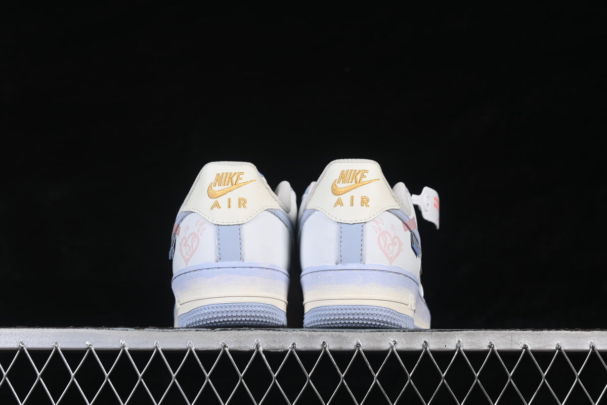 Rear view of both sneakers with gold heel branding and pale blue soles