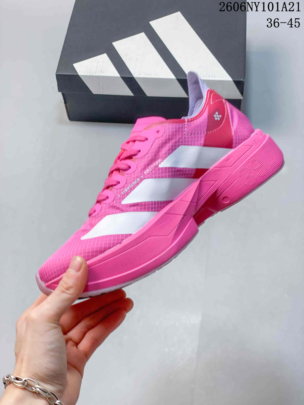 Side view showing the white stripes and pink sole