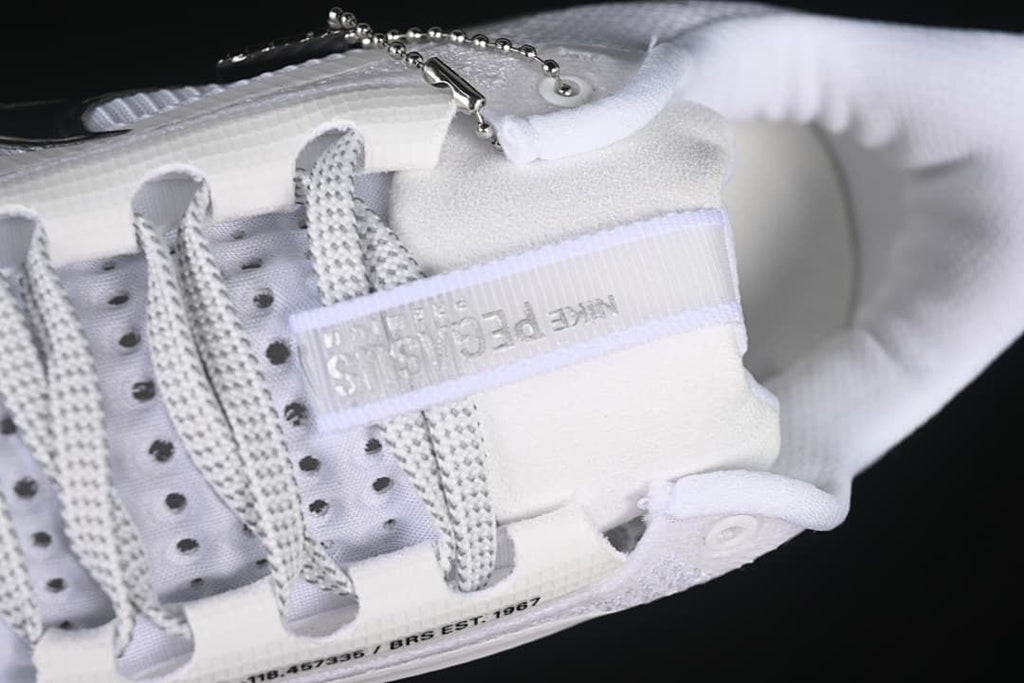 Close-up of the laces, tongue detail, and decorative lace charm.