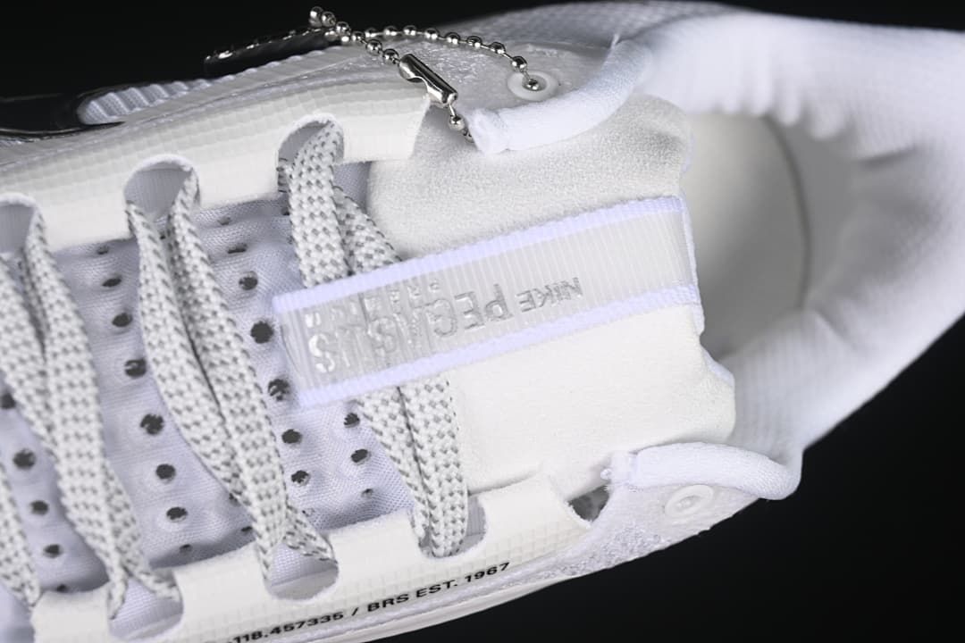 Close-up of the laces, tongue detail, and decorative lace charm.