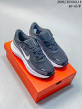 Three Nike Journey Run shoes in white with purple accents, light gray, and dark gray, shown from the side.