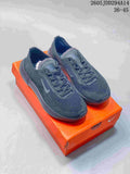 Pair of dark gray Nike Free low-top shoes displayed on an orange box