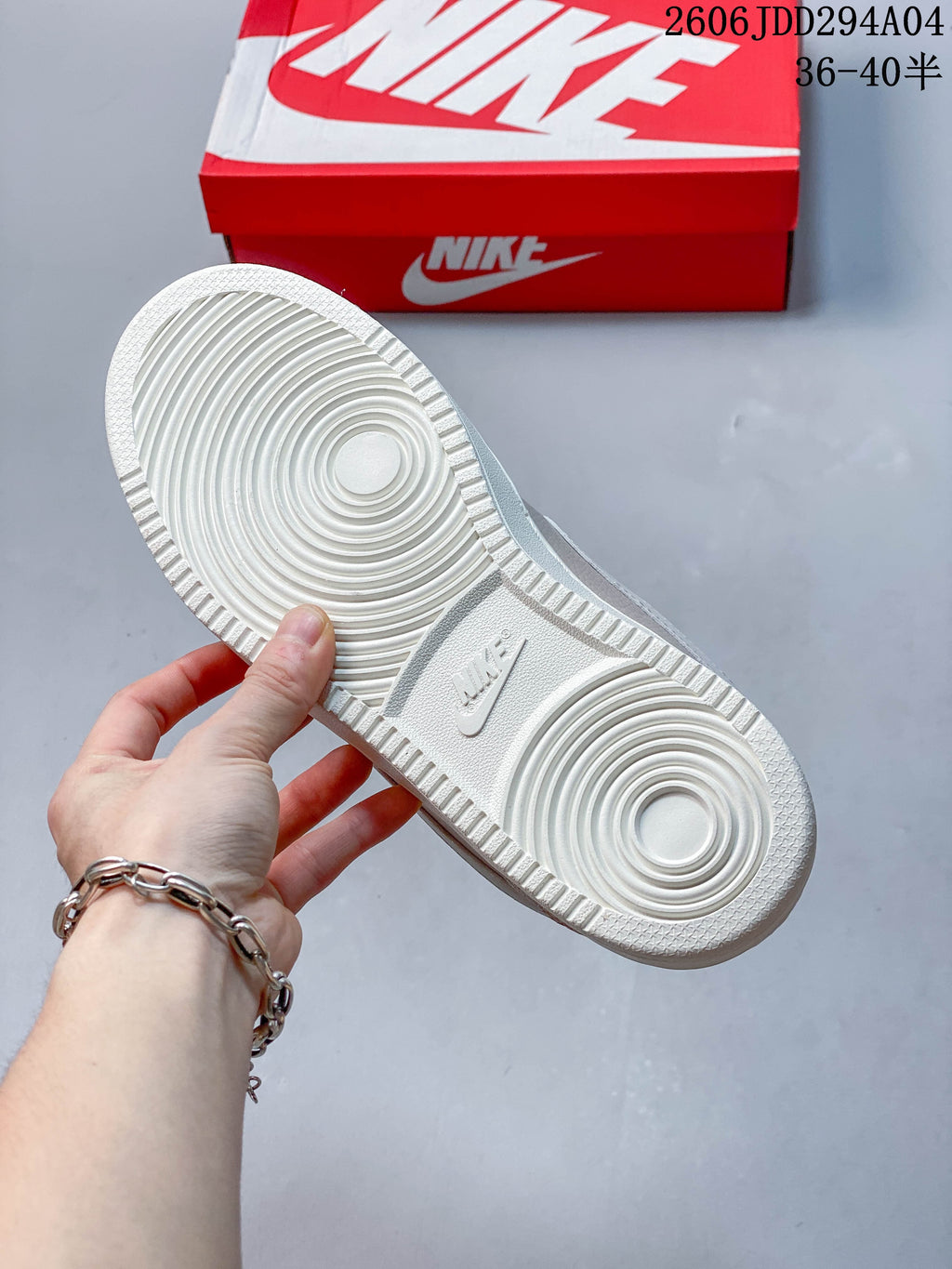Underside of the sneaker showing a white outsole with circular tread.