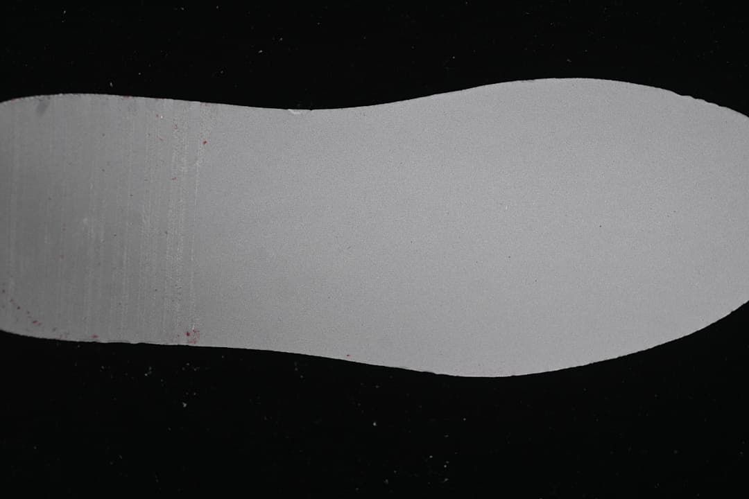 Light-colored shoe insole shown separately