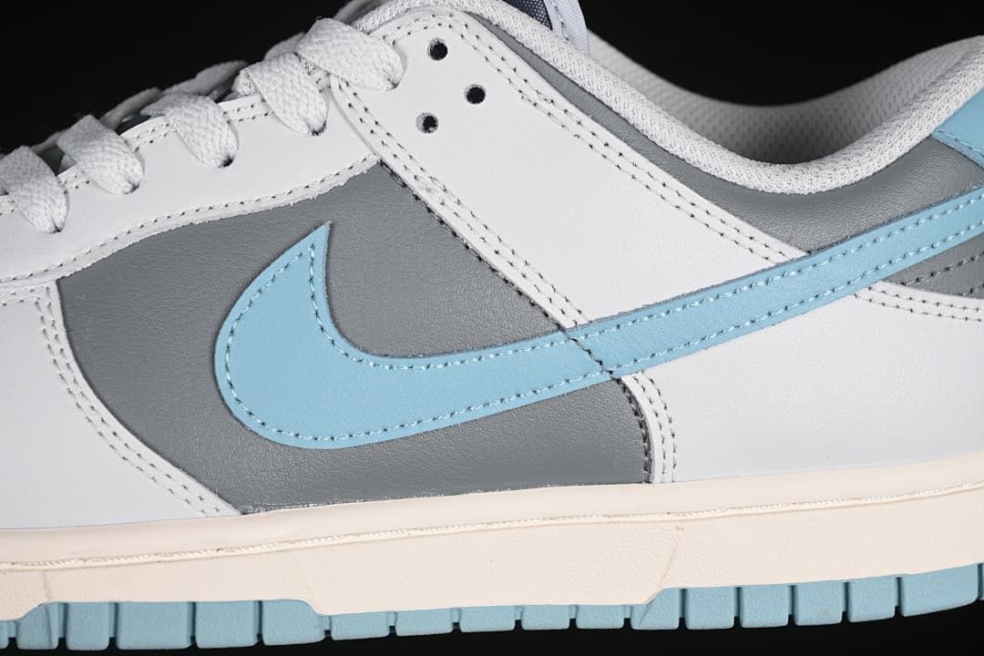 Close-up of the grey side panel, blue Swoosh, and white laces