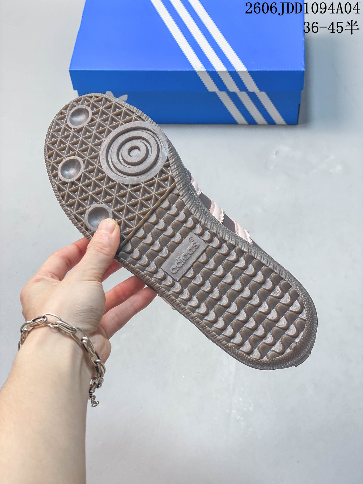 Close-up of the patterned outsole on a gray-brown Adidas Samba OG sneaker