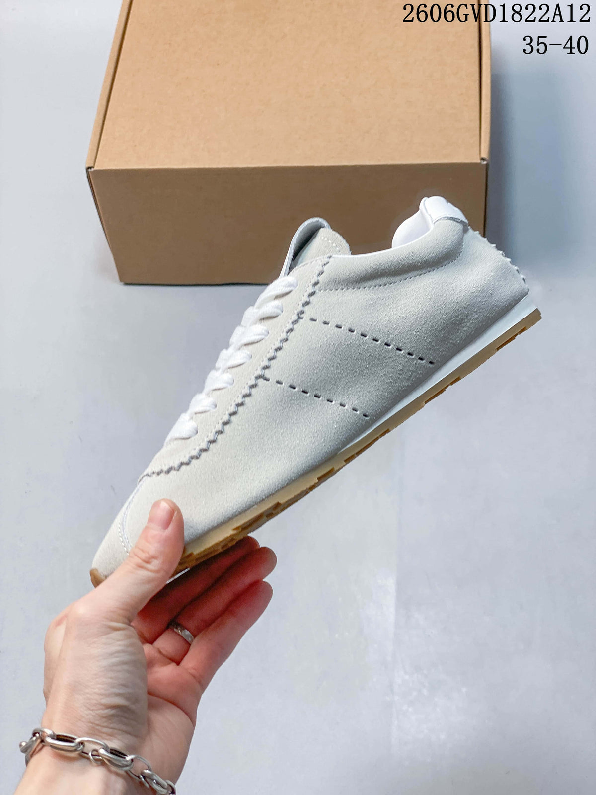 Side profile showing perforated panels, scalloped stitching, and the contrasting outsole.