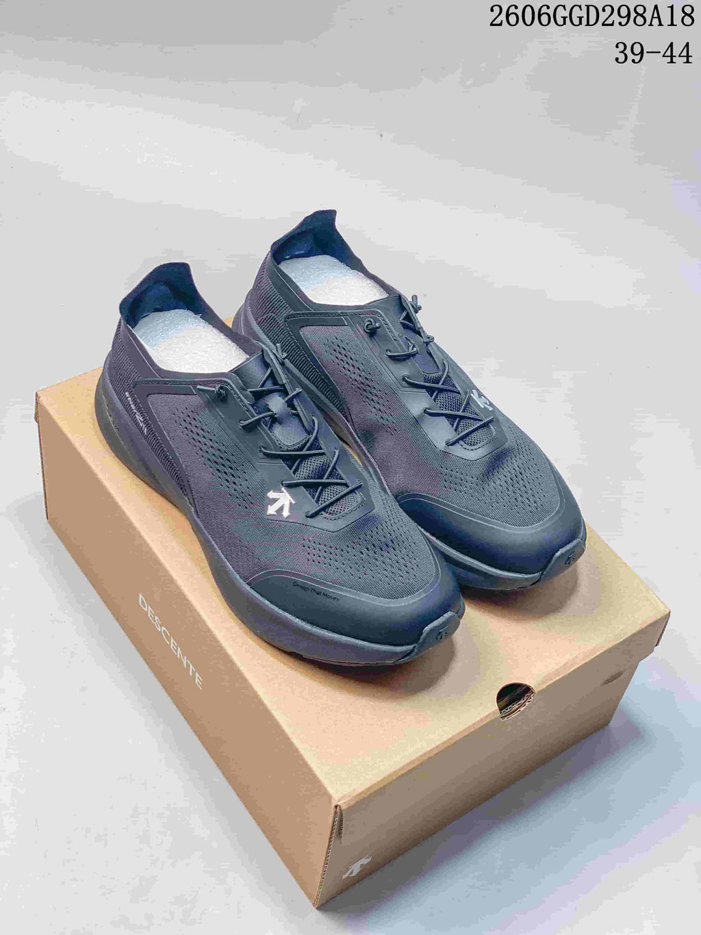 Pair of dark gray Descente Ease Air JR BOA sneakers on a Descente shoe box
