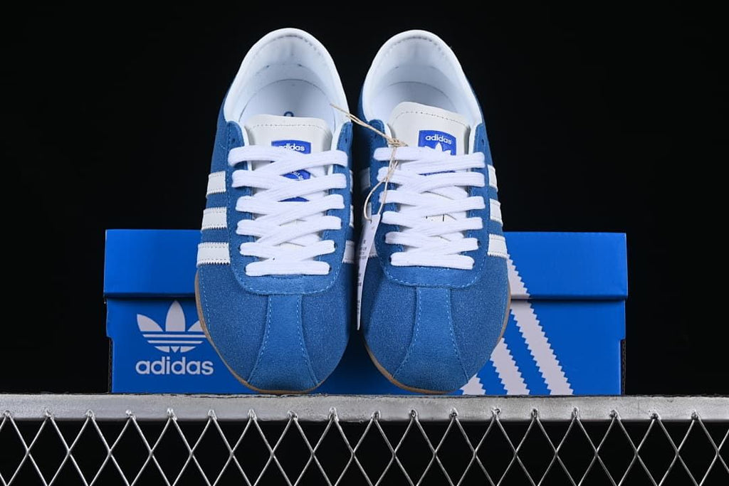 Front view of the blue and white sneakers displayed on a shoebox
