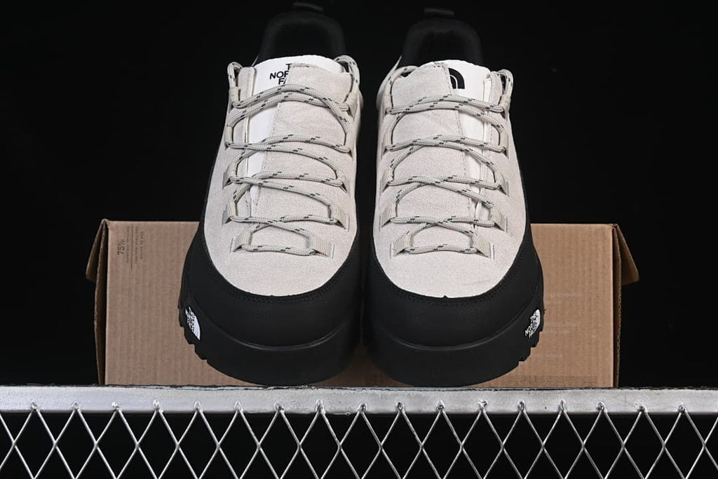 Front view of both shoes positioned on the box