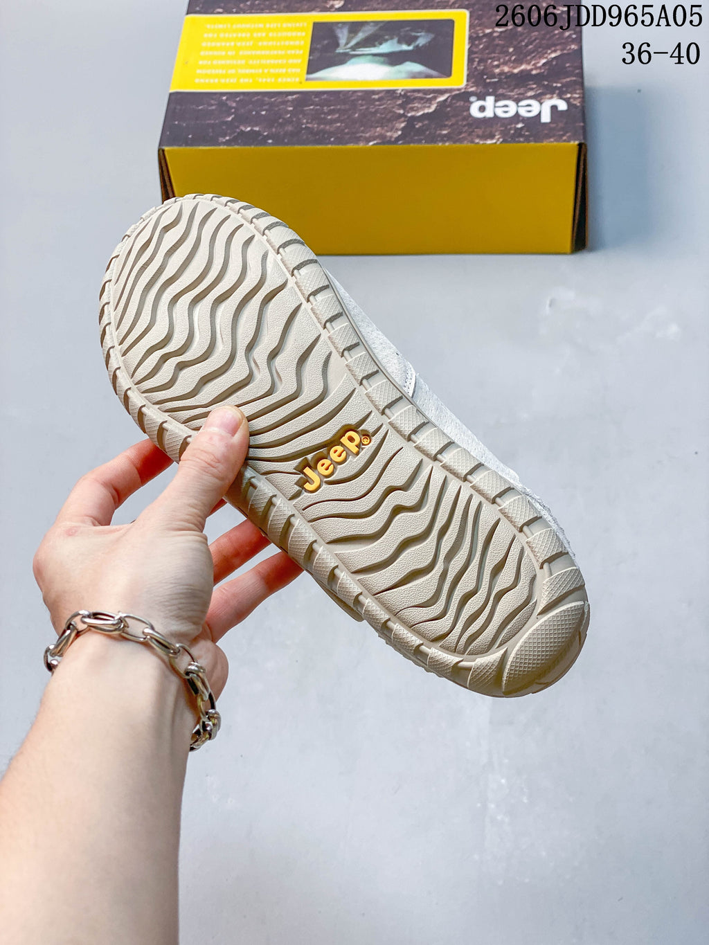 Close-up of the wavy tread pattern on the cream shoe outsole