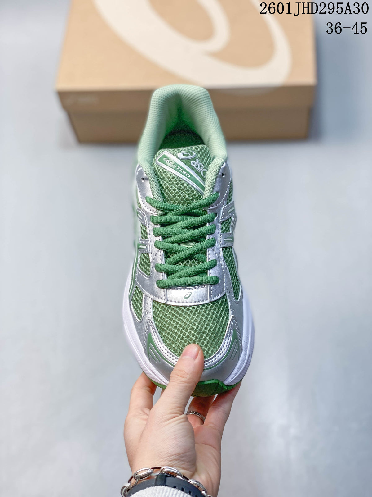 Front view showing the mesh-look toe, green laces, and silver overlays.