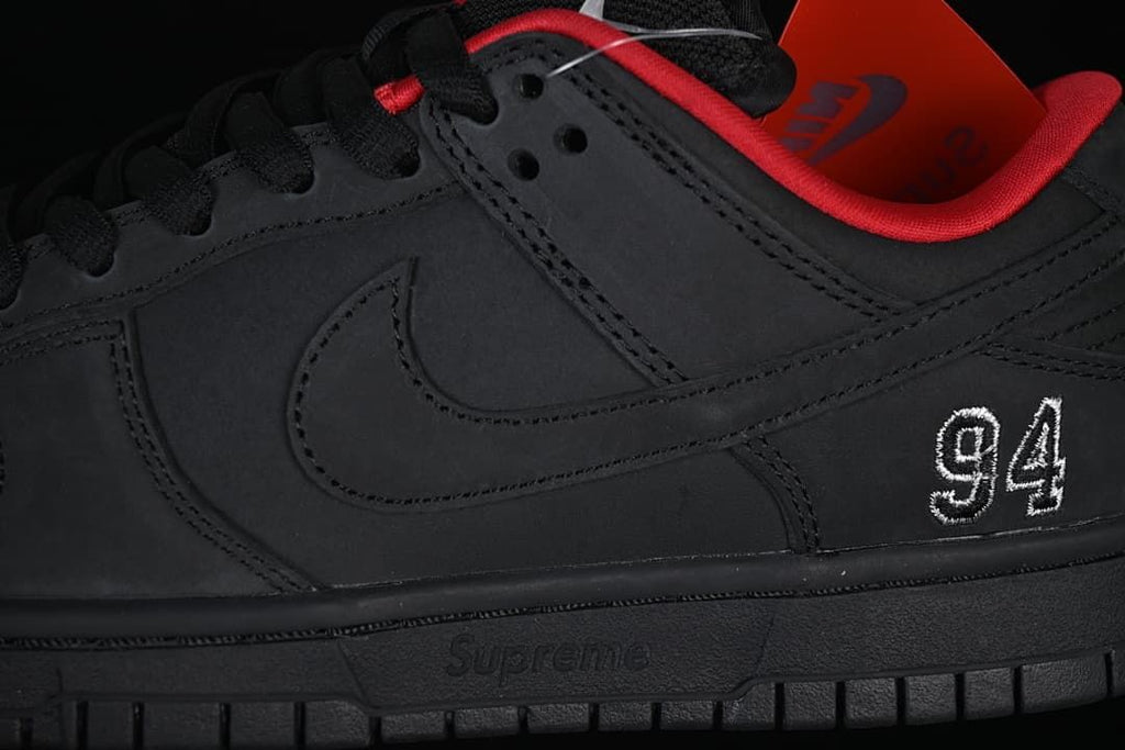 Close-up of the black side panel, Swoosh and embroidered 94 detail