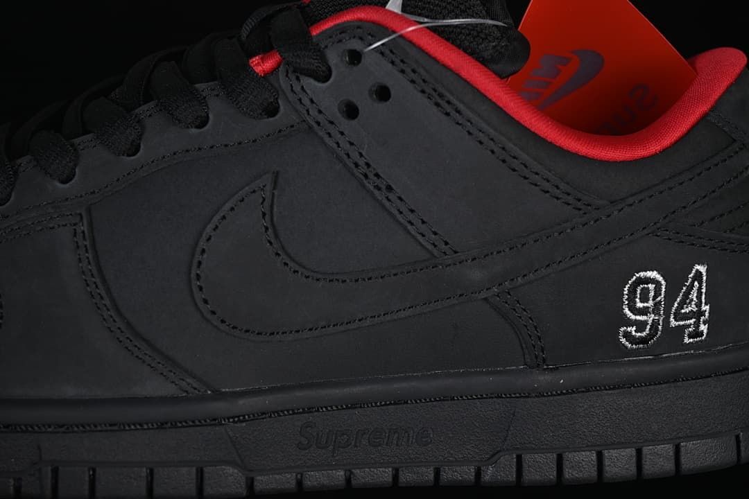 Close-up of the black side panel, Swoosh and embroidered 94 detail