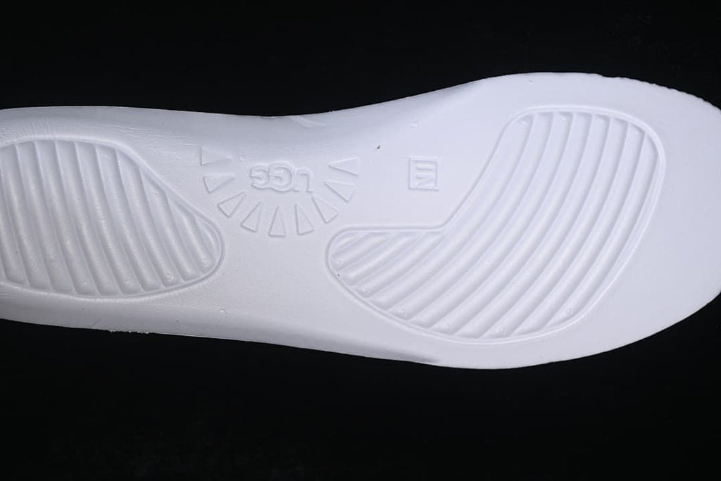 Close-up of the sneaker's white insole base with molded UGG branding