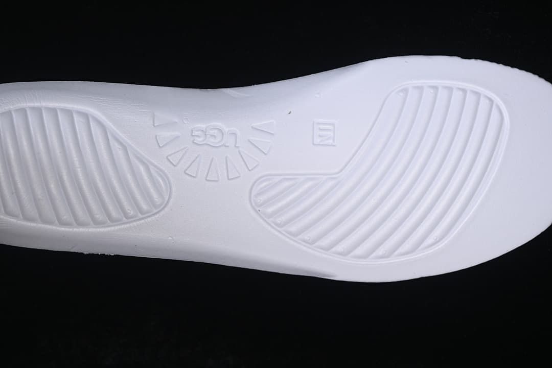 Close-up of the sneaker's white insole base with molded UGG branding