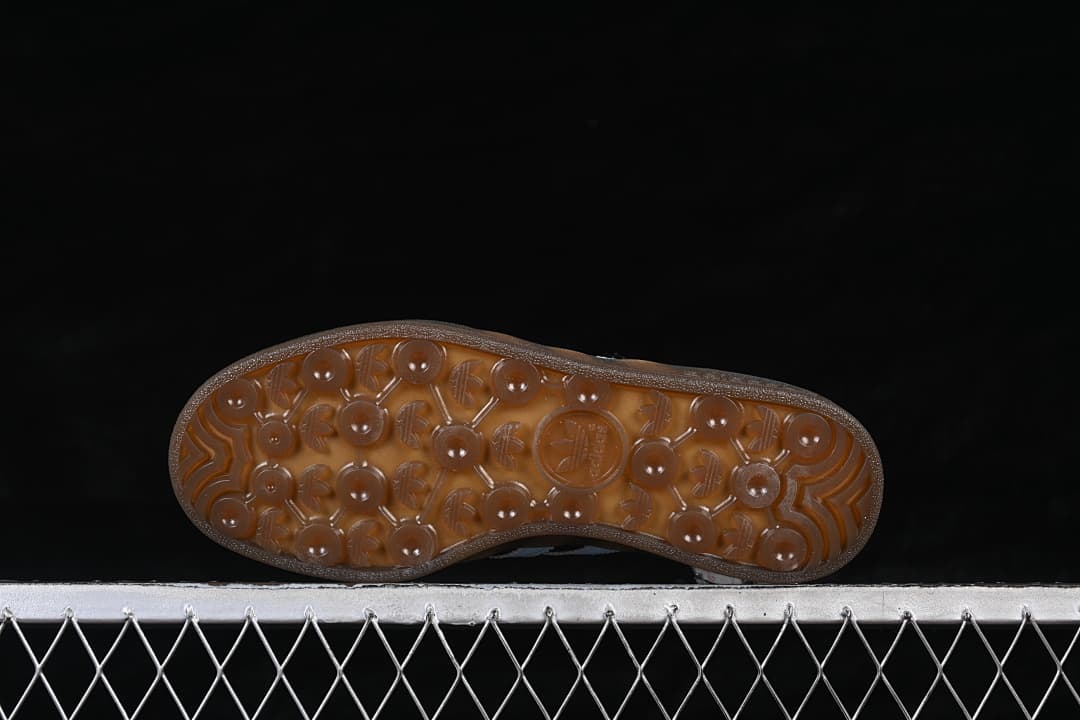 Underside of the translucent brown gum outsole with patterned tread