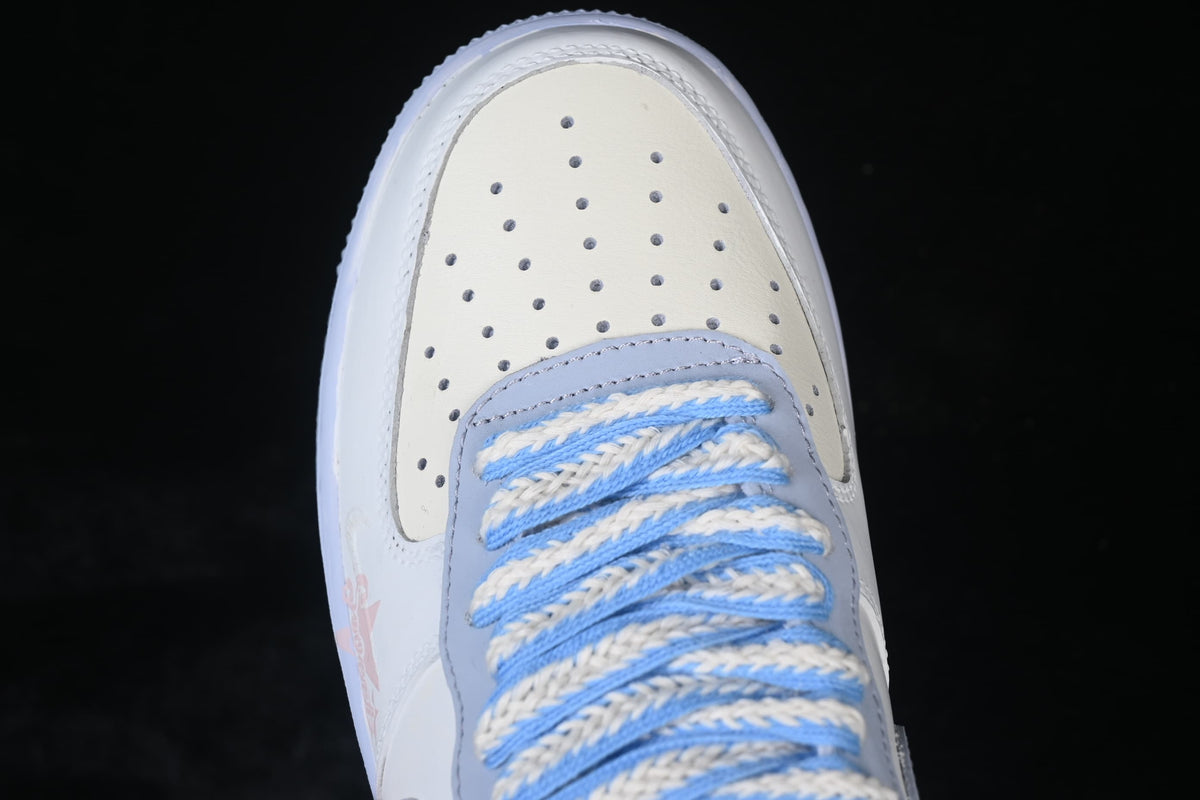 Top-down detail of the perforated toe and braided blue-and-cream laces