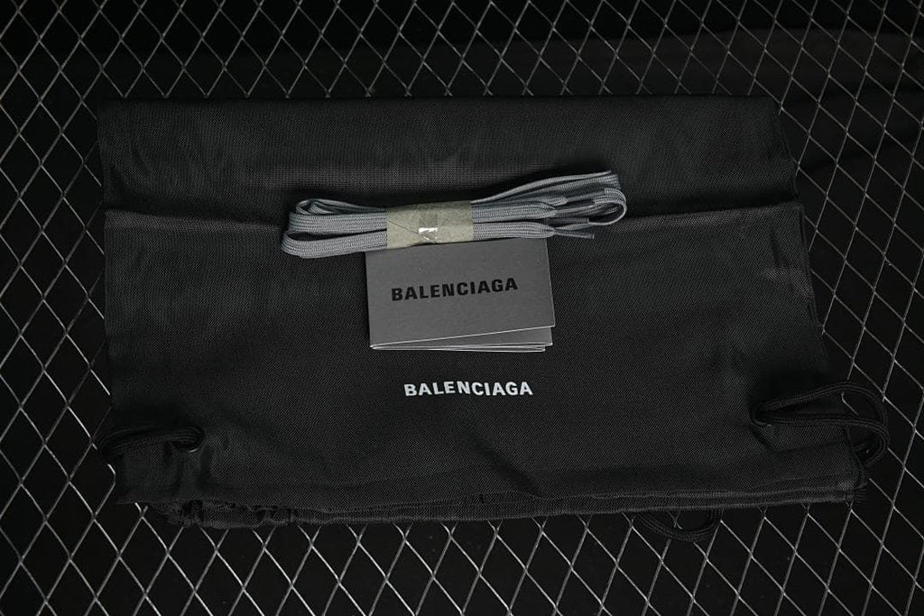 Black branded drawstring dust bag, spare grey laces, and booklet