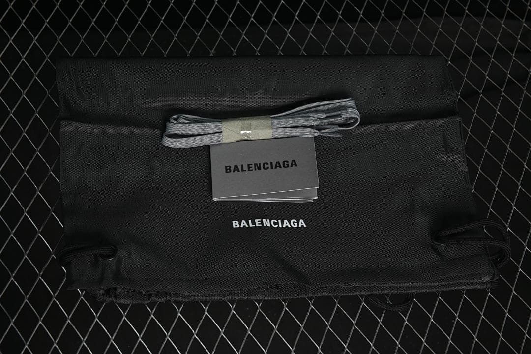 Black branded drawstring dust bag, spare grey laces, and booklet