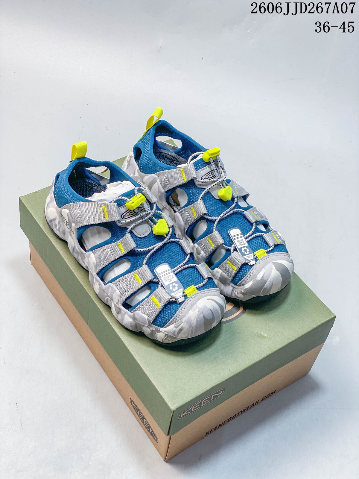 Pair of blue, gray, and yellow KEEN Astoria West sandals on a shoebox