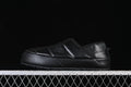 Side profile of a black quilted The North Face mule.