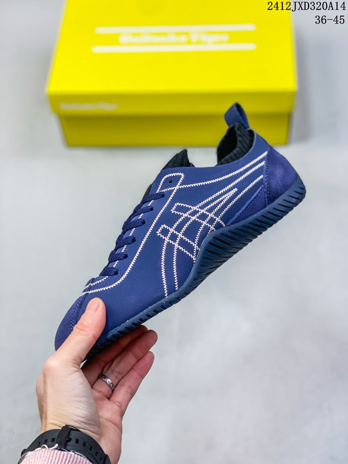 Side view showing the blue upper, white stitched detailing, and textured sole