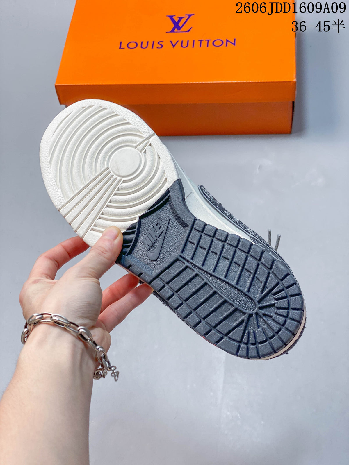 Close-up of the sneakers’ cream and dark gray outsole tread
