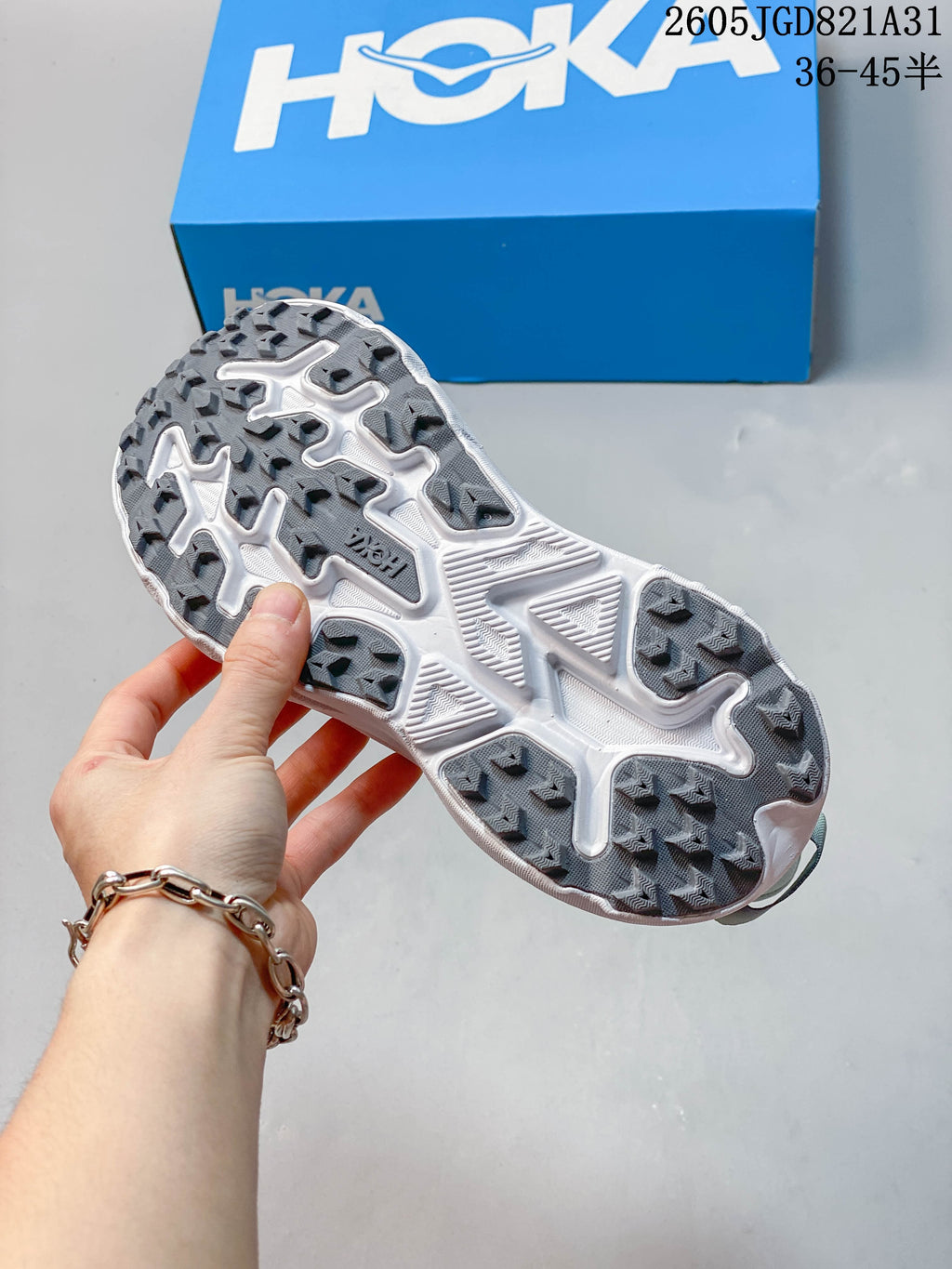 Close-up of the patterned outsole on a light blue running shoe