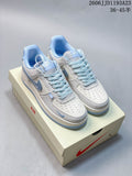 White and ice-blue low-top sneakers shown from above on a shoebox