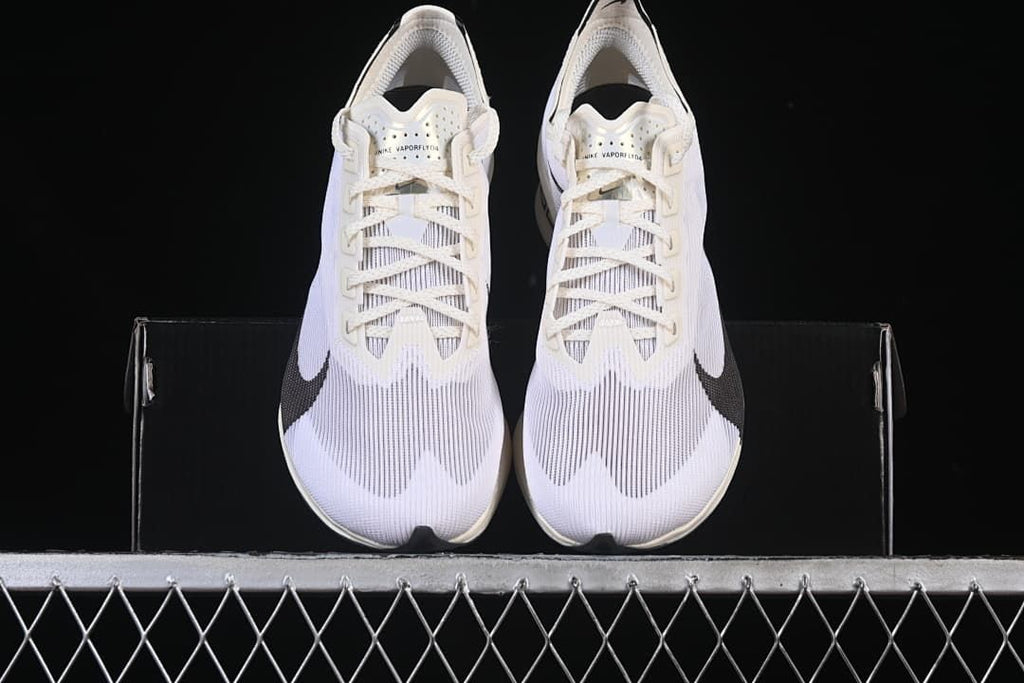 Front view of the pair of white road racing shoes with black Swoosh details