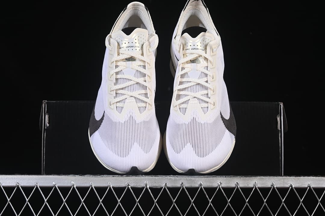 Front view of the pair of white road racing shoes with black Swoosh details