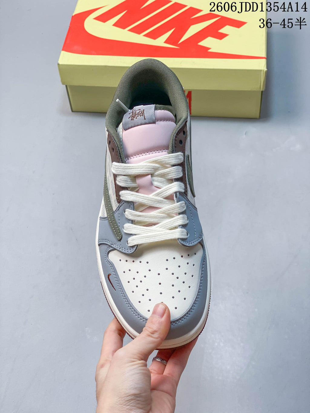 Top view of the perforated toe, white laces and pale pink tongue