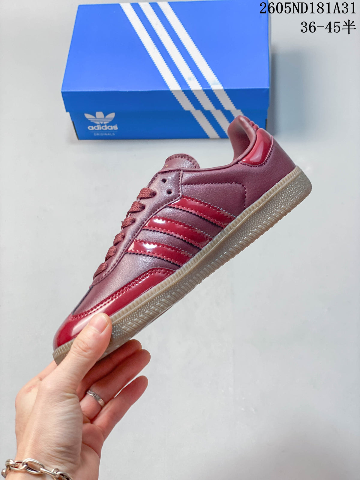 Side view of a burgundy and red Adidas Samba OG sneaker